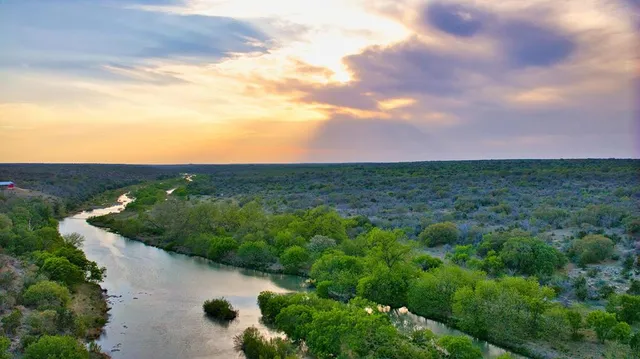 a view of a lake with a yard