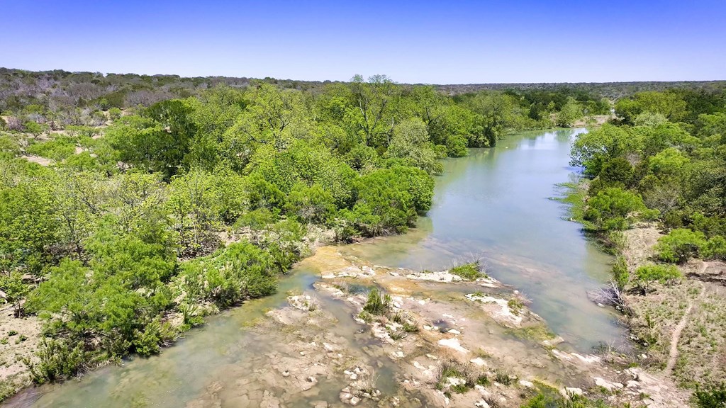 7461 Triplet Mill Road Mason, TX 76856 - Photo 17 of 46 a view of a lake with a building in the background