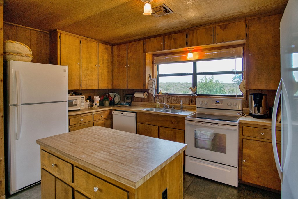 7461 Triplet Mill Road Mason, TX 76856 - Photo 31 of 46 a kitchen with a stove a sink and a refrigerator