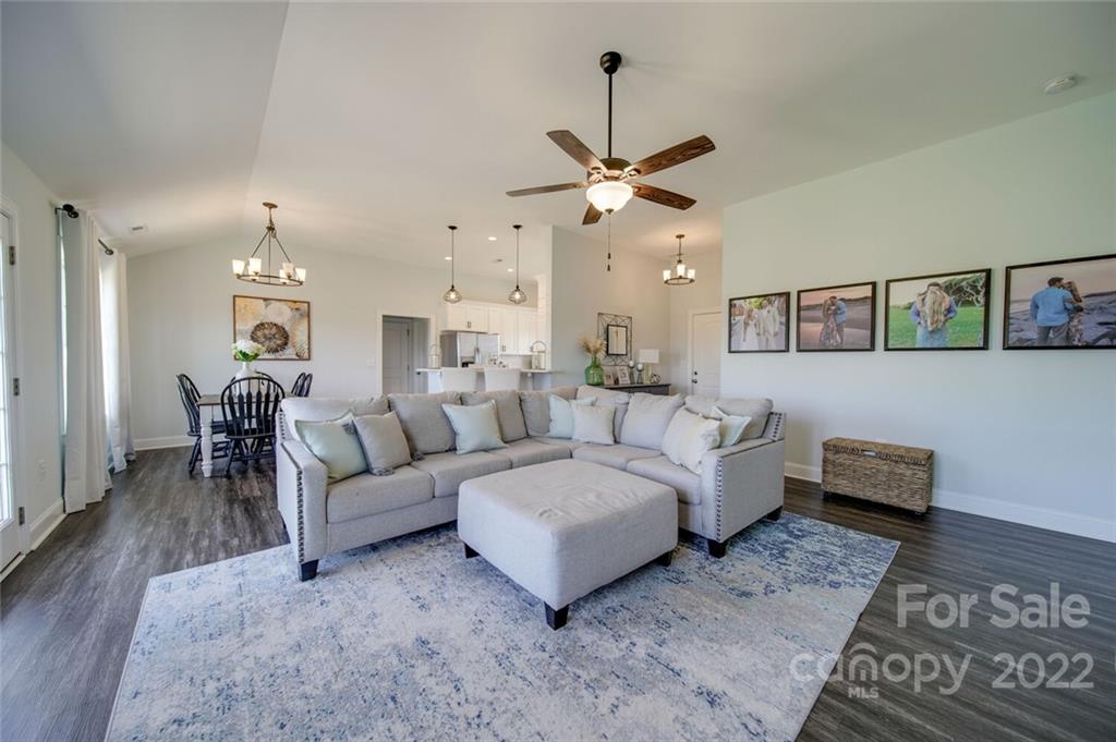 3114 East Brief Road Monroe, NC 28110 - Photo 17 of 31 a living room with furniture and a chandelier