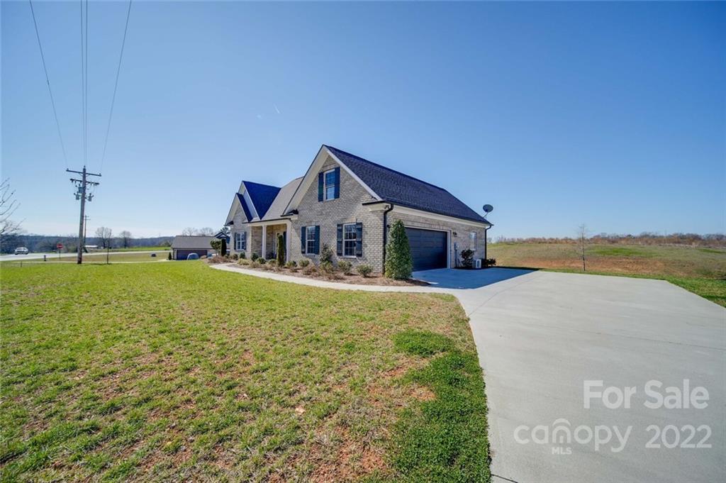 3114 East Brief Road Monroe, NC 28110 - Photo 4 of 31 a front view of a house with a garden