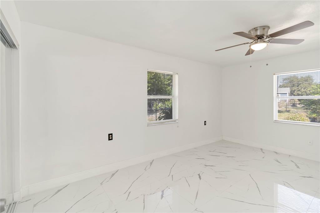 114 Palencia Road Auburndale, FL 33823 - Photo 17 of 27 an empty room with windows and fan
