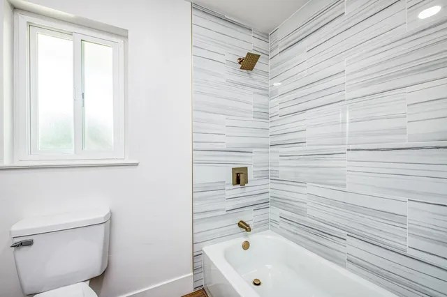 a bathroom with a toilet a sink and a mirror