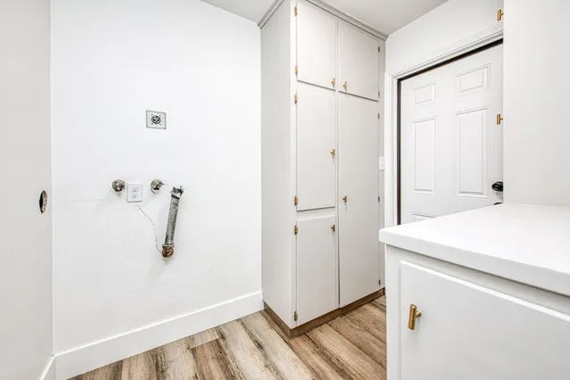 a living room with furniture a window and a potted plant
