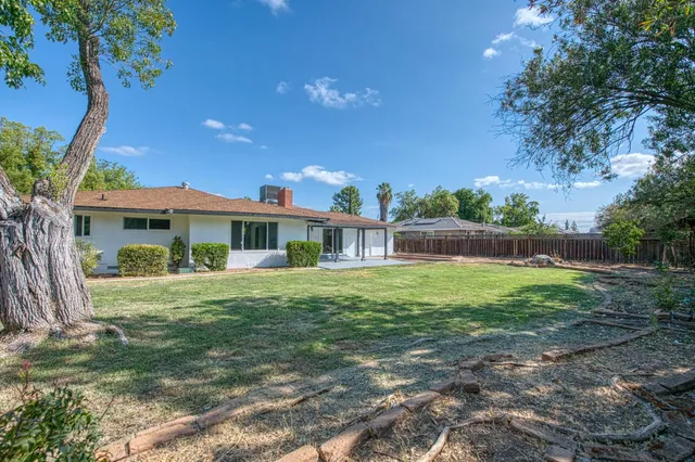 a front view of house with yard outdoor seating and green space