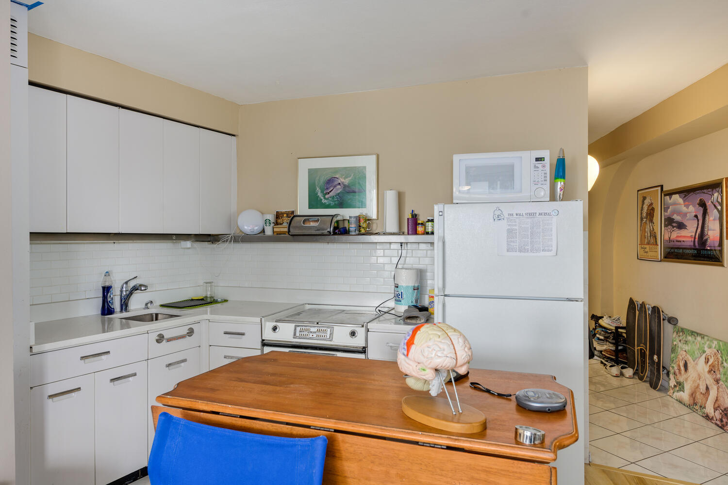 300 North State Street, Unit 4303 Chicago, IL 60654 - Photo 3 of 15 a kitchen with a sink a stove and white cabinets