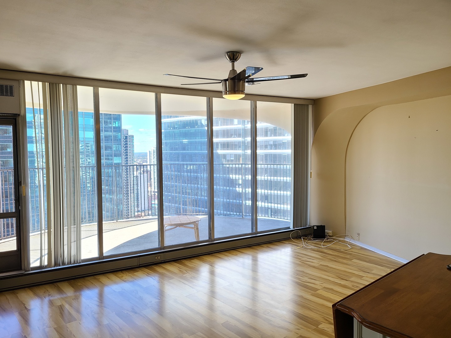 300 North State Street, Unit 4303 Chicago, IL 60654 - Photo 4 of 15 a view of empty room with wooden floor and fan