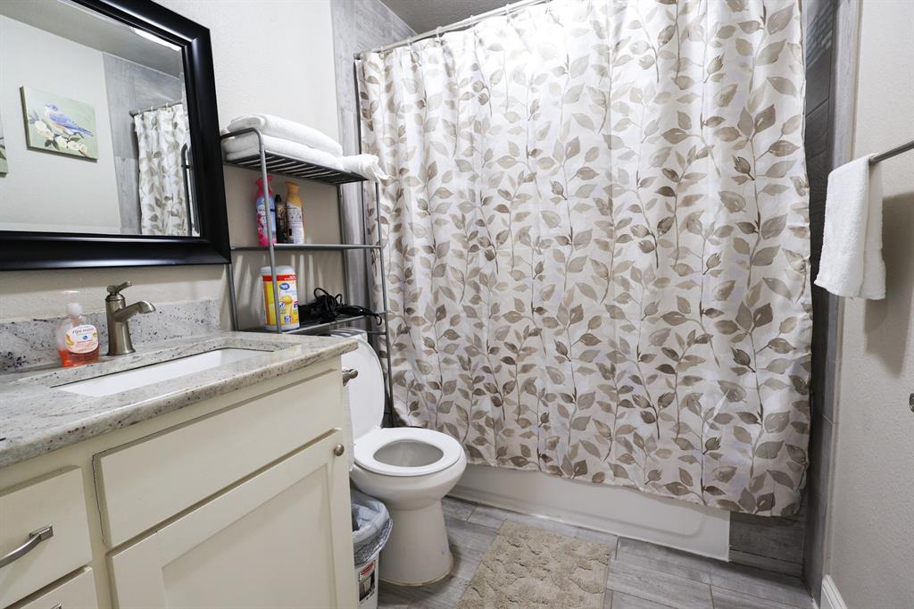 605 East Graham Street McKinney, TX 75069 - Photo 11 of 22 a bathroom with a toilet and a sink