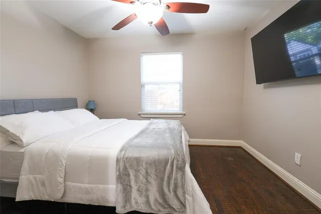 a bedroom with a bed and flat screen tv