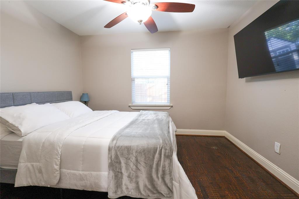 605 East Graham Street McKinney, TX 75069 - Photo 12 of 22 a bedroom with a bed and flat screen tv