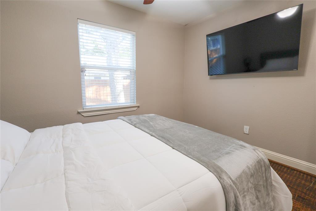 605 East Graham Street McKinney, TX 75069 - Photo 14 of 22 a bedroom with a flat screen tv and a window