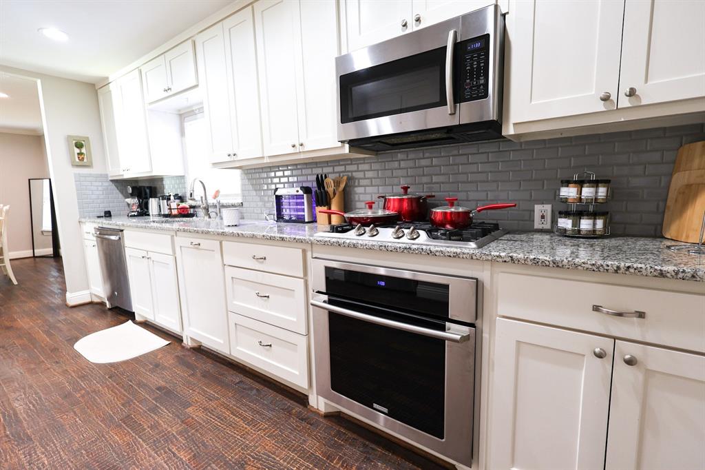 605 East Graham Street McKinney, TX 75069 - Photo 9 of 22 a kitchen with stainless steel appliances granite countertop a sink a stove a microwave and cabinets