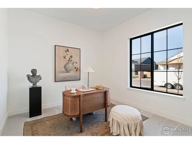 a living room with furniture a window and a flat screen tv