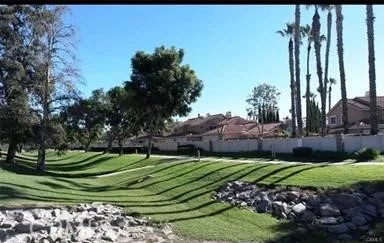 a view of a golf course with a house