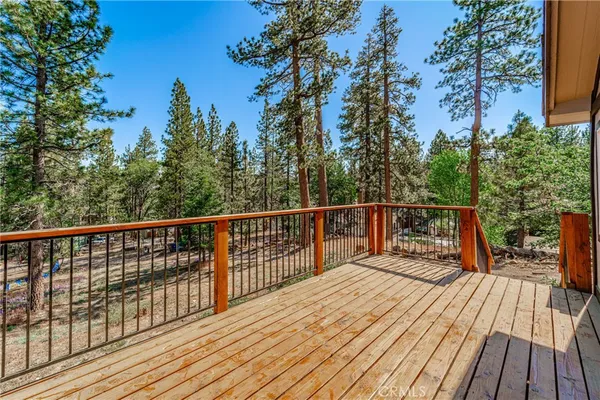 a view of balcony with wooden floor and fence