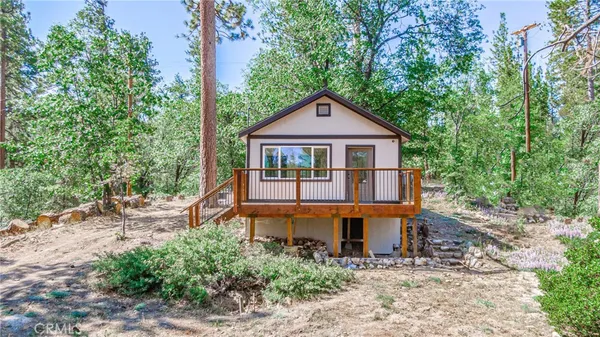 an outdoor view of house with trees around