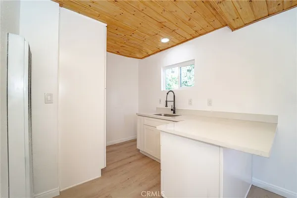 a kitchen with a sink and a mirror