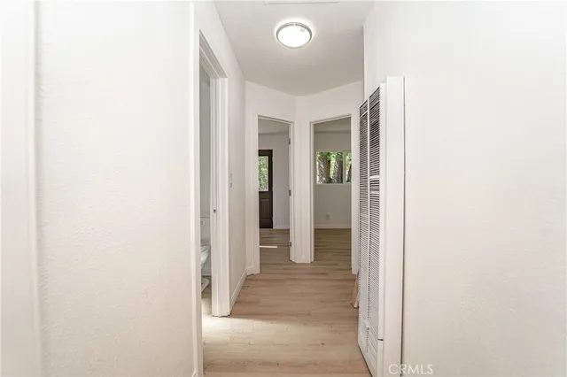 a view of a hallway with wooden floor