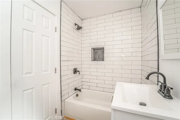 a bathroom with a sink a bathtub and shower