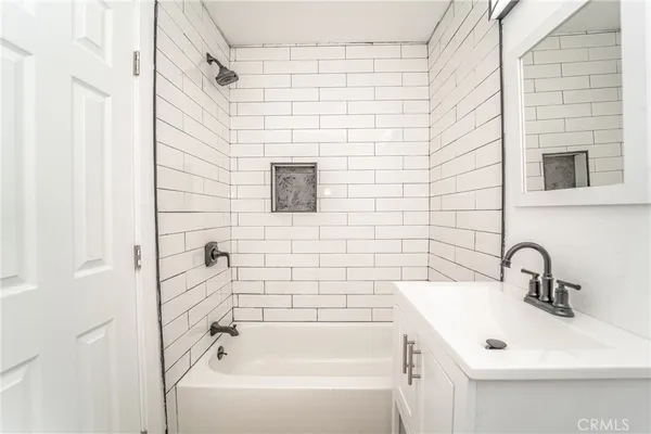 a bathroom with a sink a mirror and shower