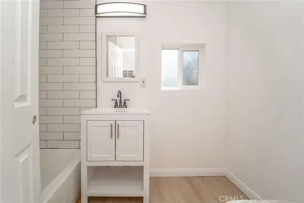 a bathroom with a sink a vanity and a mirror