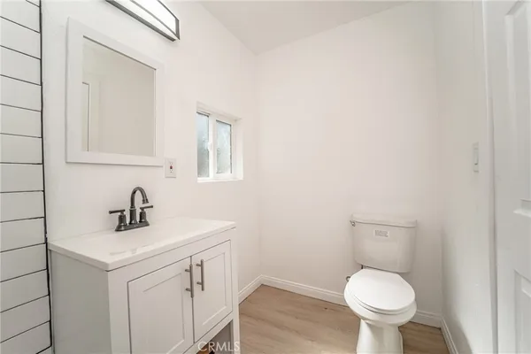 a bathroom with a sink toilet and a mirror
