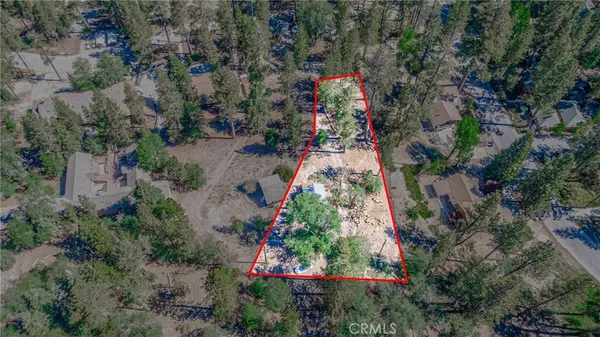 an aerial view of residential house with outdoor space and trees