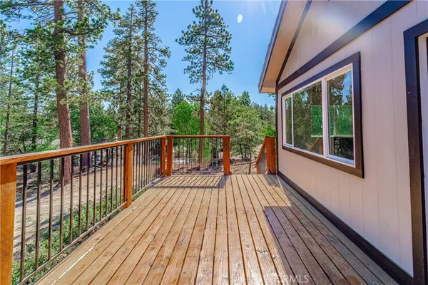a view of balcony with wooden floor and fence