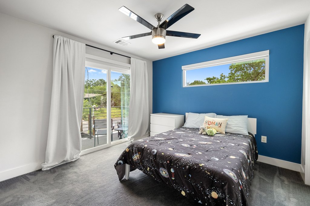1182 Ridgeway Drive, Unit A Austin, TX 78702 - Photo 21 of 35 a bed sitting in a spacious bedroom next to a window