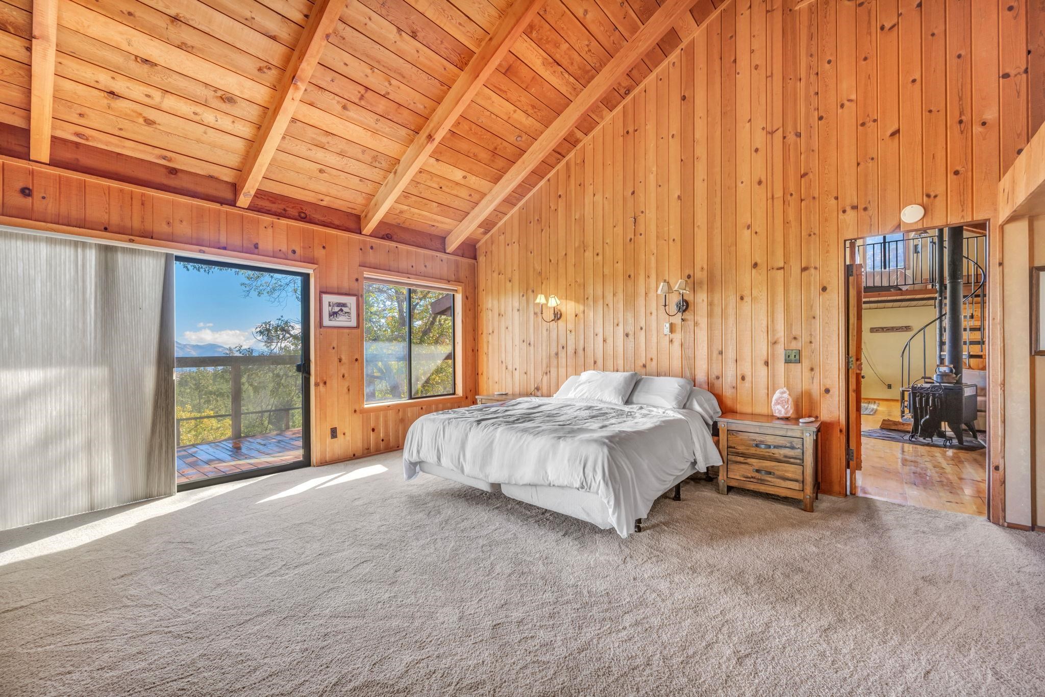 740-935 Sugar Loaf Road Doyle, CA 96109 - Photo 15 of 25 a spacious bedroom with a large bed and a chandelier