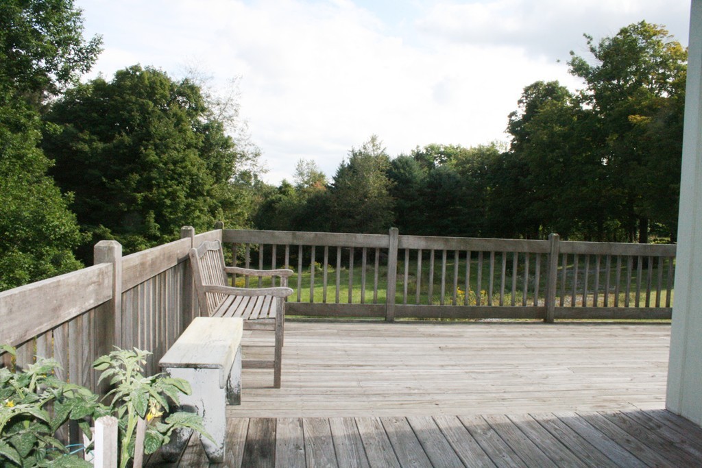18 Willicutt Road Chesterfield, MA 01012 - Photo 18 of 27 a balcony with wooden floor table and chairs