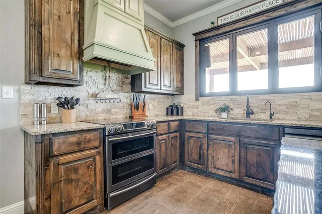 a kitchen with stainless steel appliances granite countertop a stove and cabinets