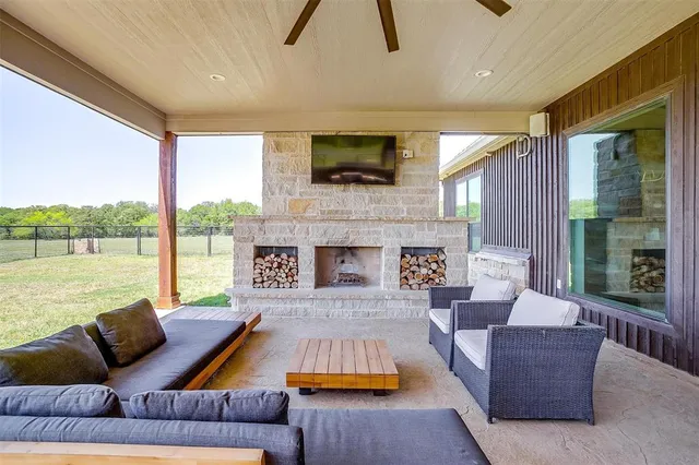 a living room with furniture fireplace and a large window