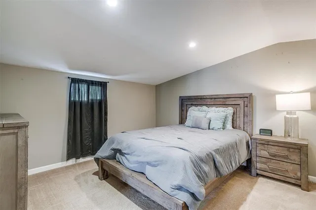 a bedroom with a bed and a night stand