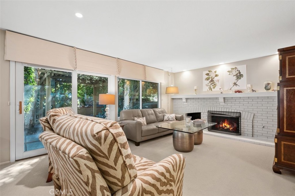 32 Colonial Irvine, CA 92620 - Photo 11 of 33 a living room with furniture large window and fireplace
