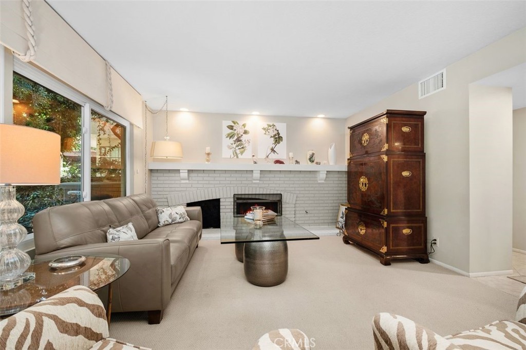 32 Colonial Irvine, CA 92620 - Photo 12 of 33 a living room with furniture and a fireplace