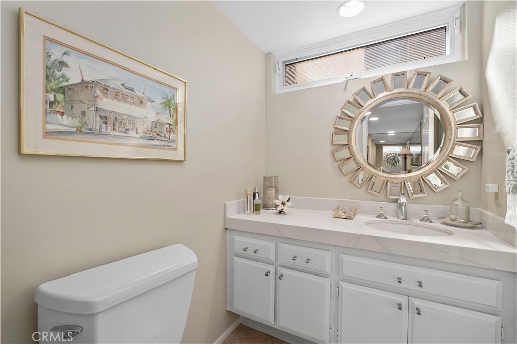 32 Colonial Irvine, CA 92620 - Photo 15 of 33 a bathroom with a toilet a sink and a mirror