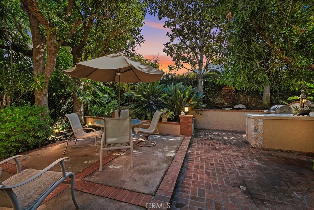 32 Colonial Irvine, CA 92620 - Photo 2 of 33 a view of a patio with table and chairs under an umbrella with large trees