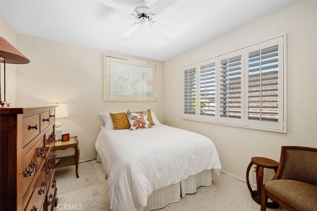 32 Colonial Irvine, CA 92620 - Photo 25 of 33 a bedroom with a bed and a chair