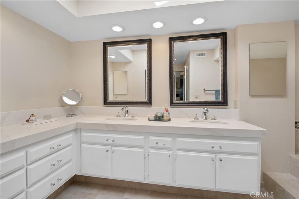 32 Colonial Irvine, CA 92620 - Photo 29 of 33 a bathroom with double vanity sinks and a mirror