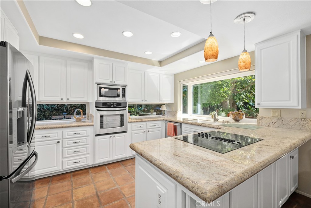 32 Colonial Irvine, CA 92620 - Photo 8 of 33 a kitchen with granite countertop a sink a counter top space stainless steel appliances and cabinets