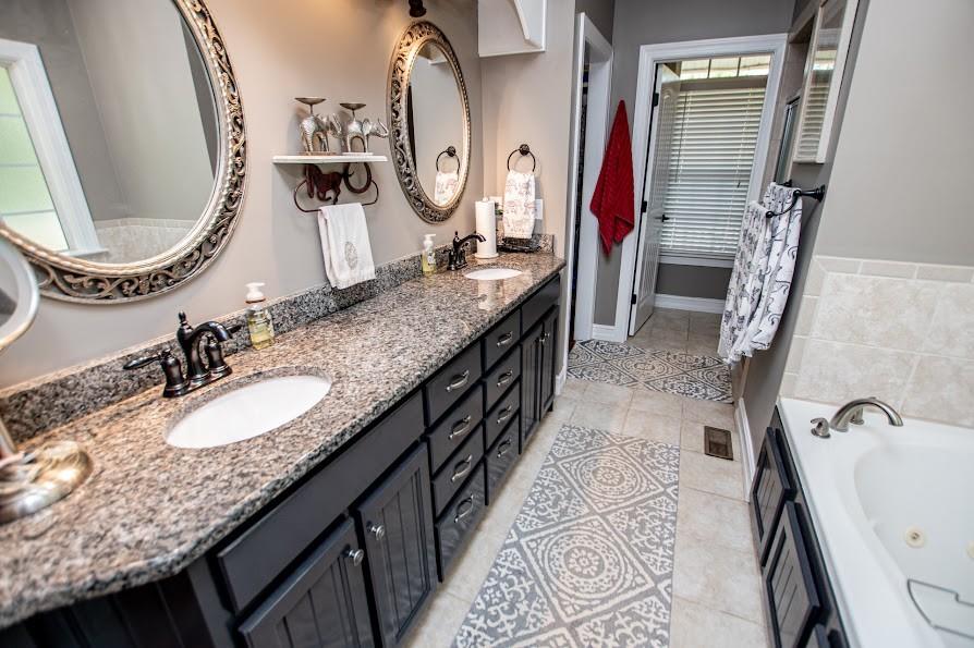 575 Liberty Church Road Carrollton, GA 30116 - Photo 24 of 95 a bathroom with a granite countertop double vanity sink and a mirror