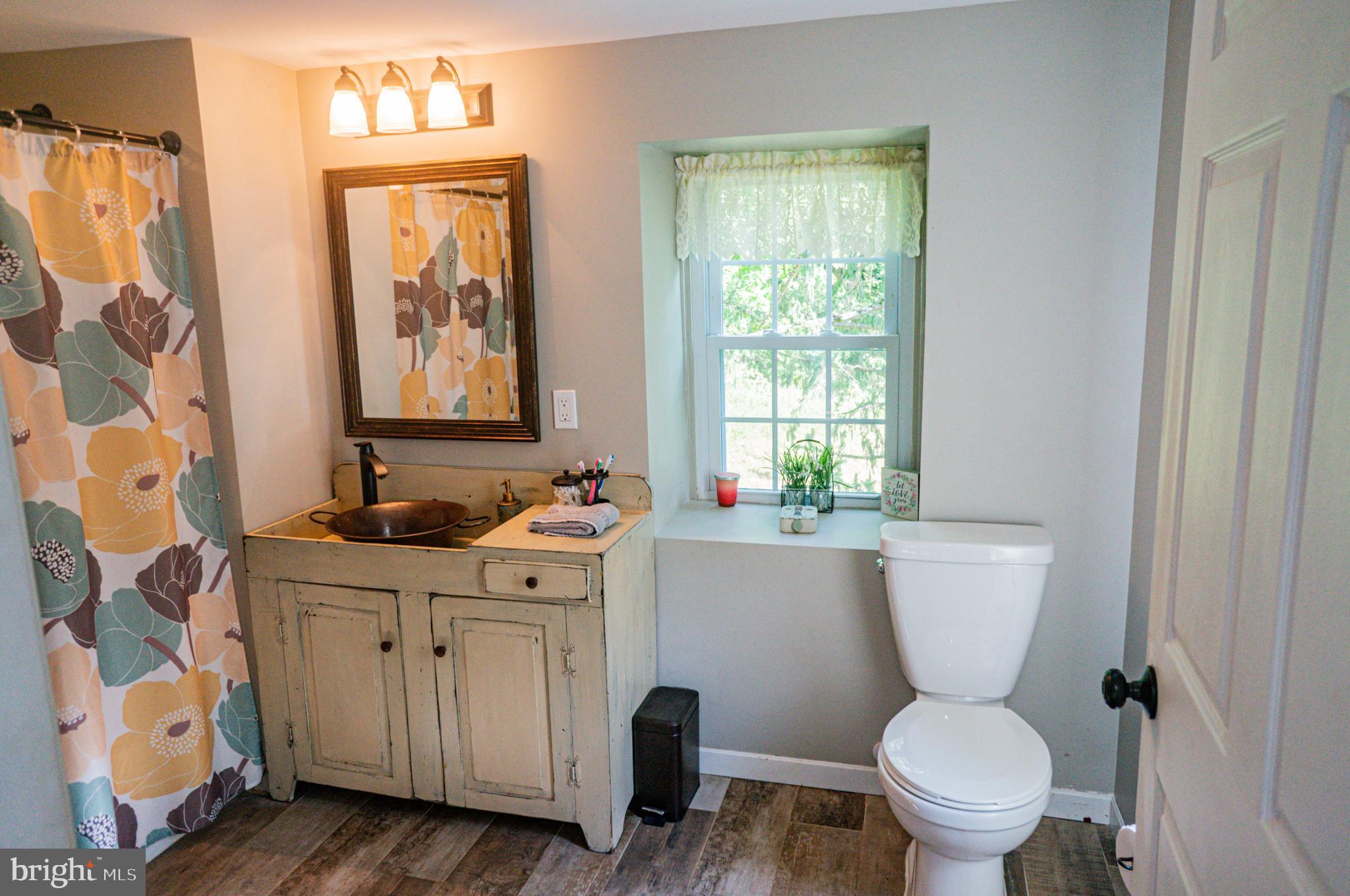 988 Kratz Road Glen Rock, PA 17327 - Photo 53 of 97 a bathroom with a toilet sink and mirror