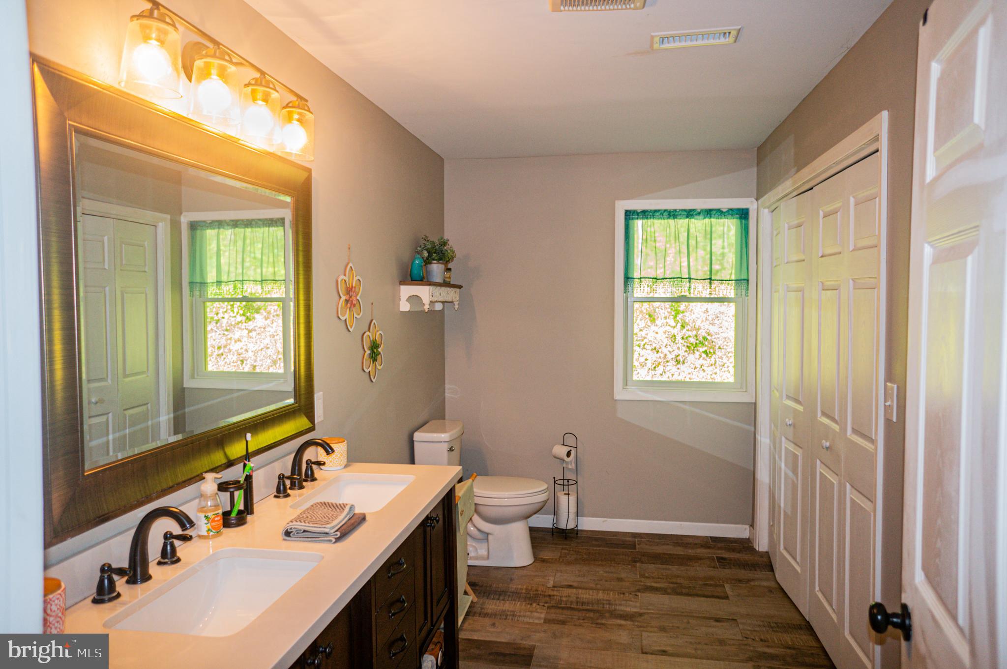 988 Kratz Road Glen Rock, PA 17327 - Photo 55 of 97 a bathroom with a double vanity sink toilet and a mirror