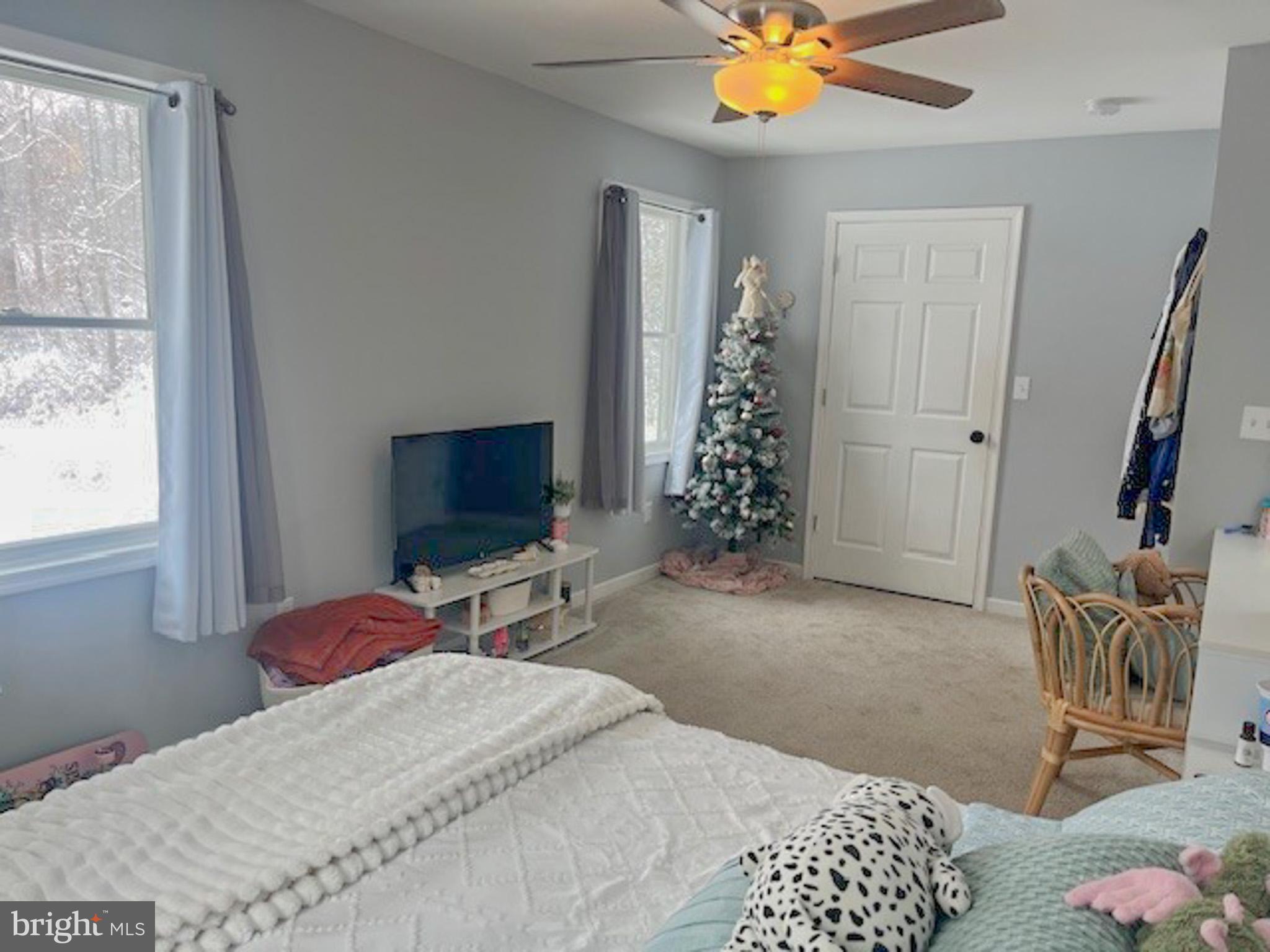 988 Kratz Road Glen Rock, PA 17327 - Photo 59 of 97 a bedroom with a bed and a chandelier