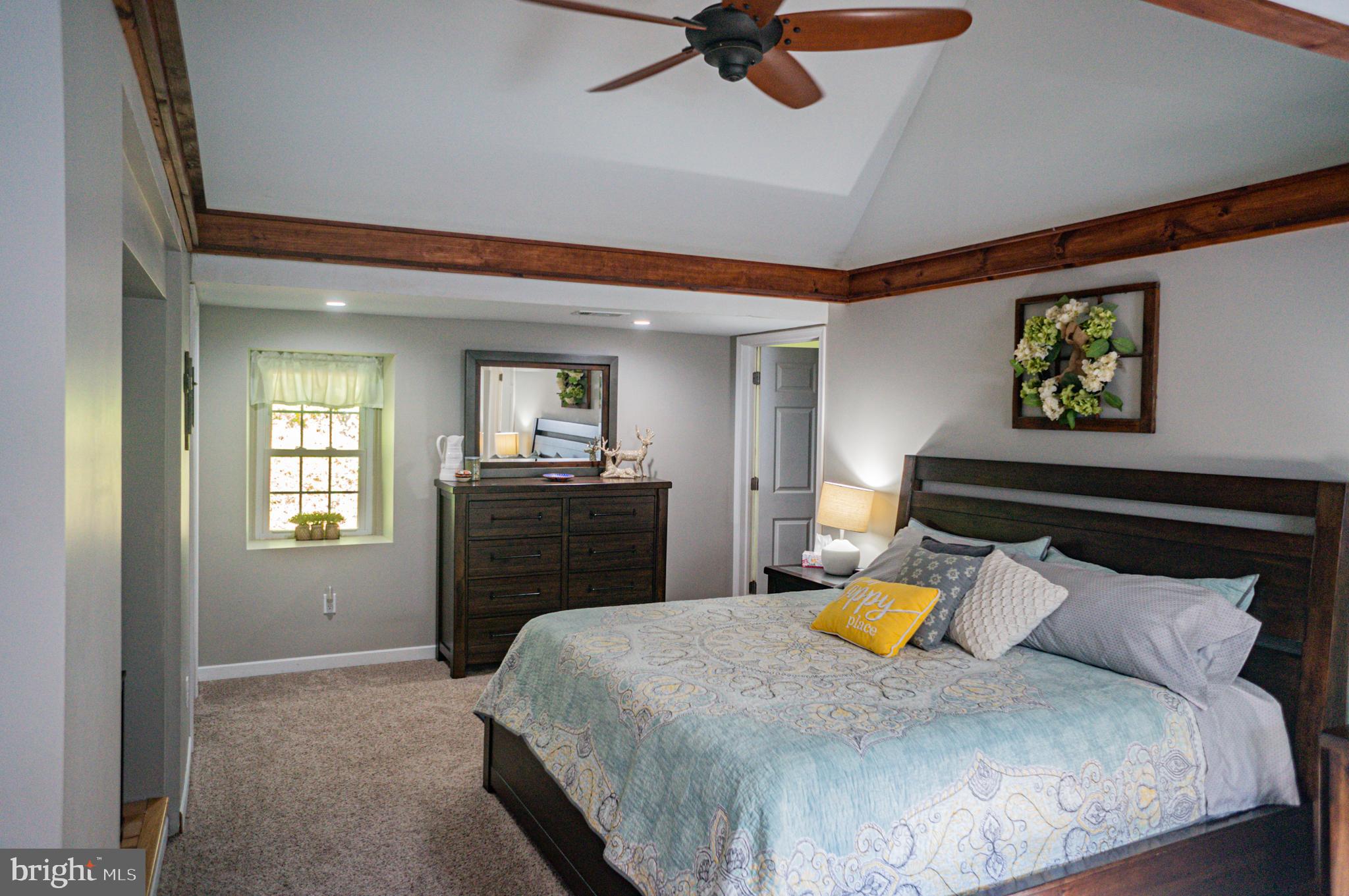 988 Kratz Road Glen Rock, PA 17327 - Photo 8 of 97 a bedroom with a bed and a chandelier