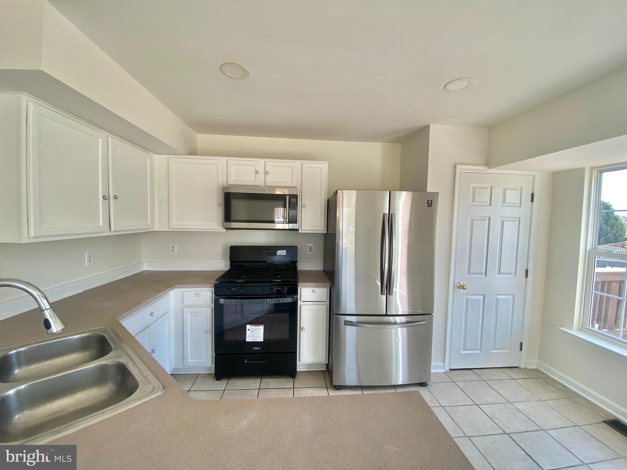 17324 Sligo Loop Dumfries, VA 22026 - Photo 2 of 39 a kitchen with granite countertop a refrigerator and a sink