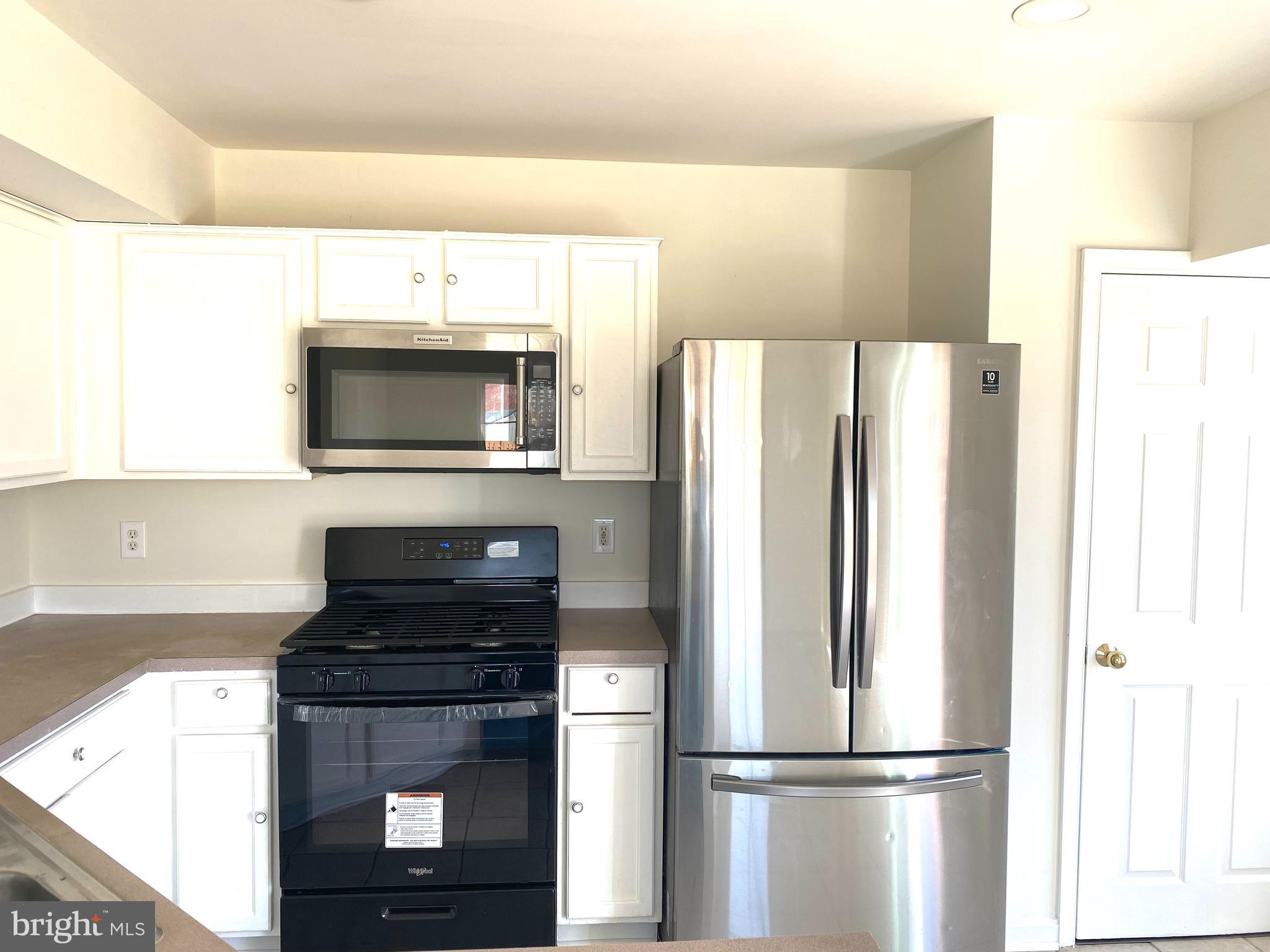 17324 Sligo Loop Dumfries, VA 22026 - Photo 3 of 39 a kitchen with a refrigerator and a stove top oven