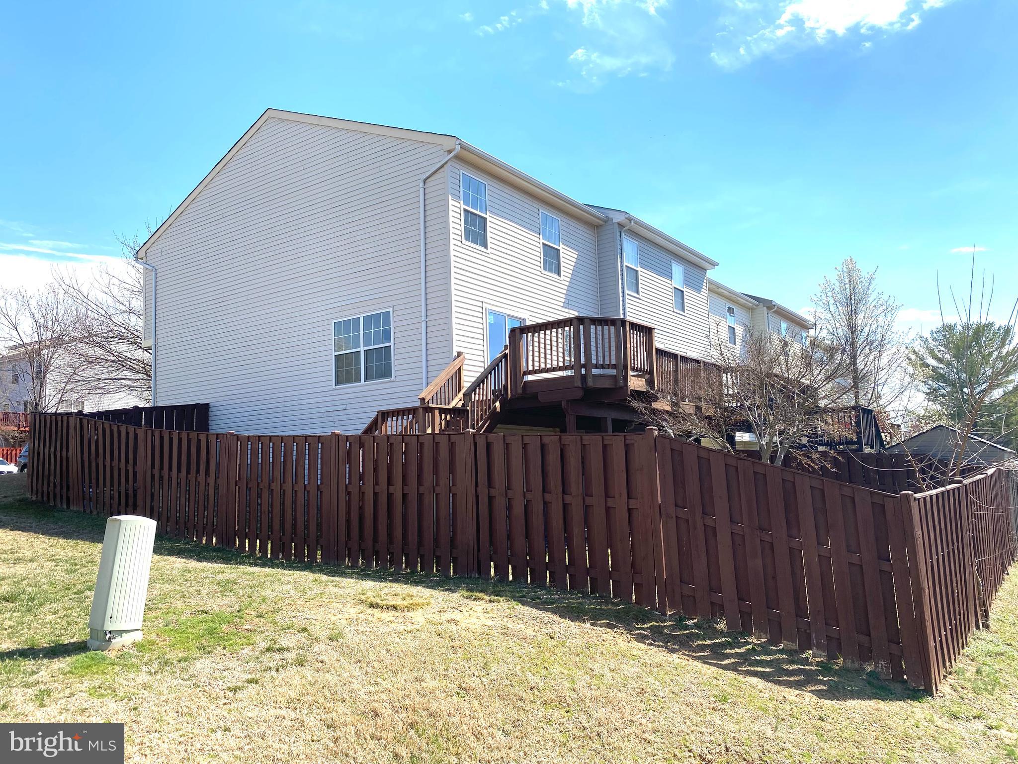 17324 Sligo Loop Dumfries, VA 22026 - Photo 38 of 39 a backyard of a house with swimming pool and wooden fence