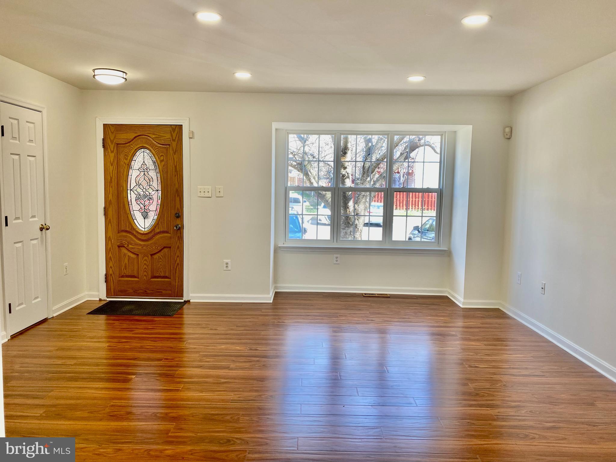 17324 Sligo Loop Dumfries, VA 22026 - Photo 8 of 39 an empty room with wooden floor and windows